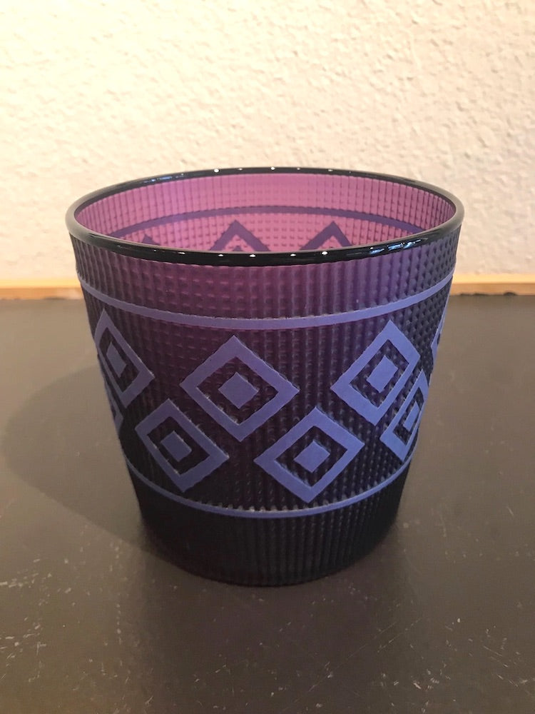 Purple blown glass vessel by Preston Singletary featuring light blue geometric patterns inspired by traditional Northwest Coast basketry.