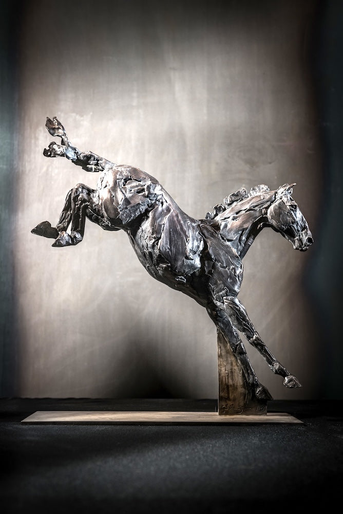 Bronze sculpture of a horse kicking in the air by Stephanie Revennaugh